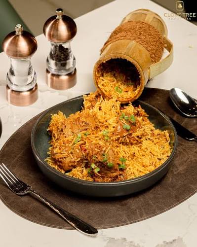 Bamboo biryani at Café Malabar — Malabar biryani steamed inside a green bamboo log, sealed with banana leaf.